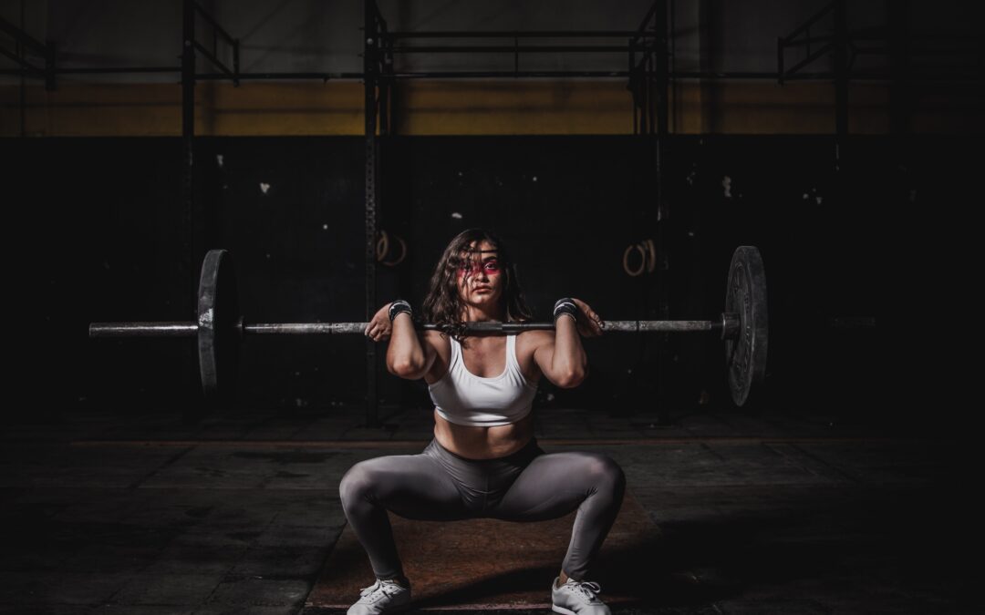 A fit and muscular fitness coach from South Africa performing a kettlebell exercise